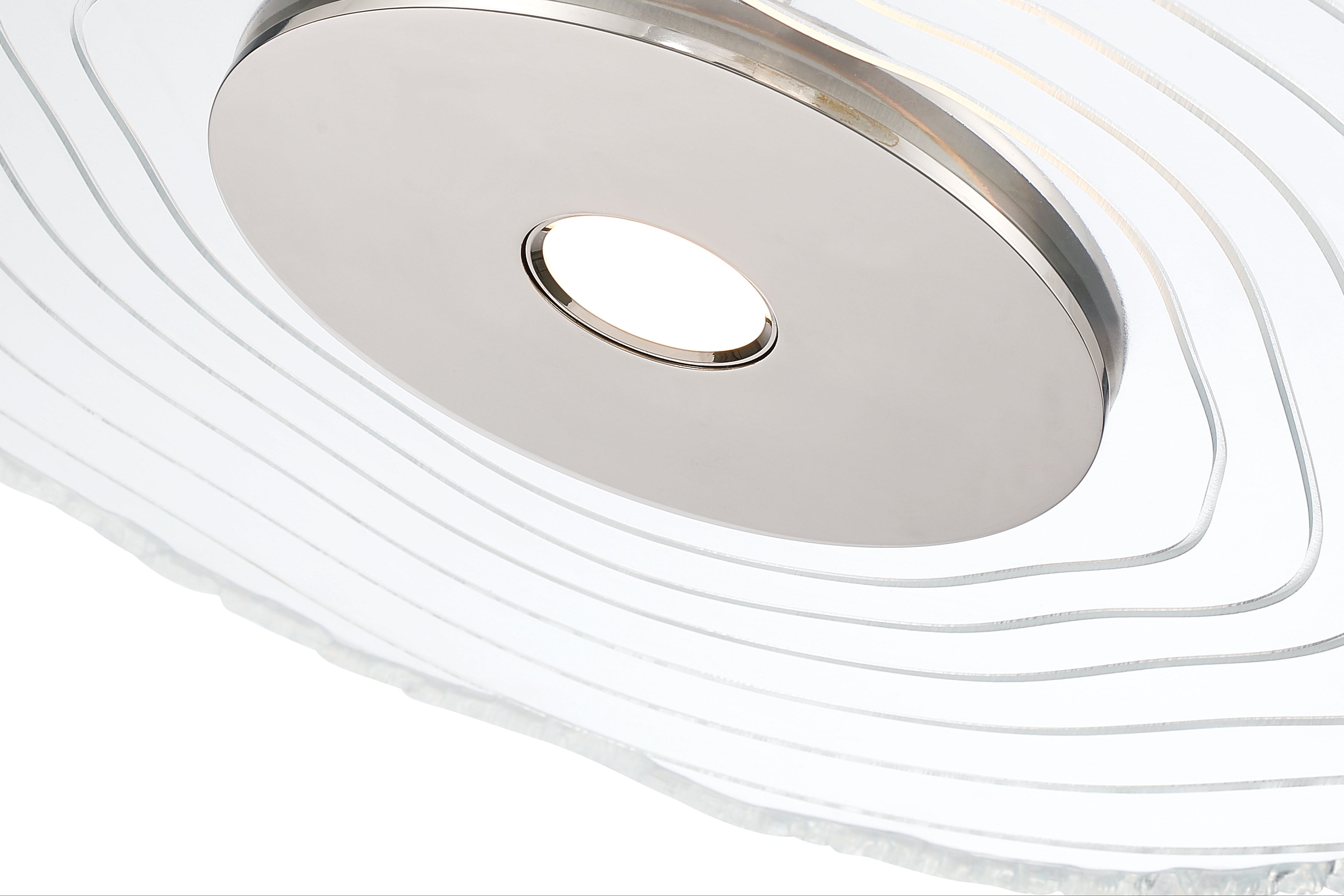 Close-up of a modern ceiling light fixture featuring an integrated LED and a clear resin surround of a wood slice. Launching 2026.