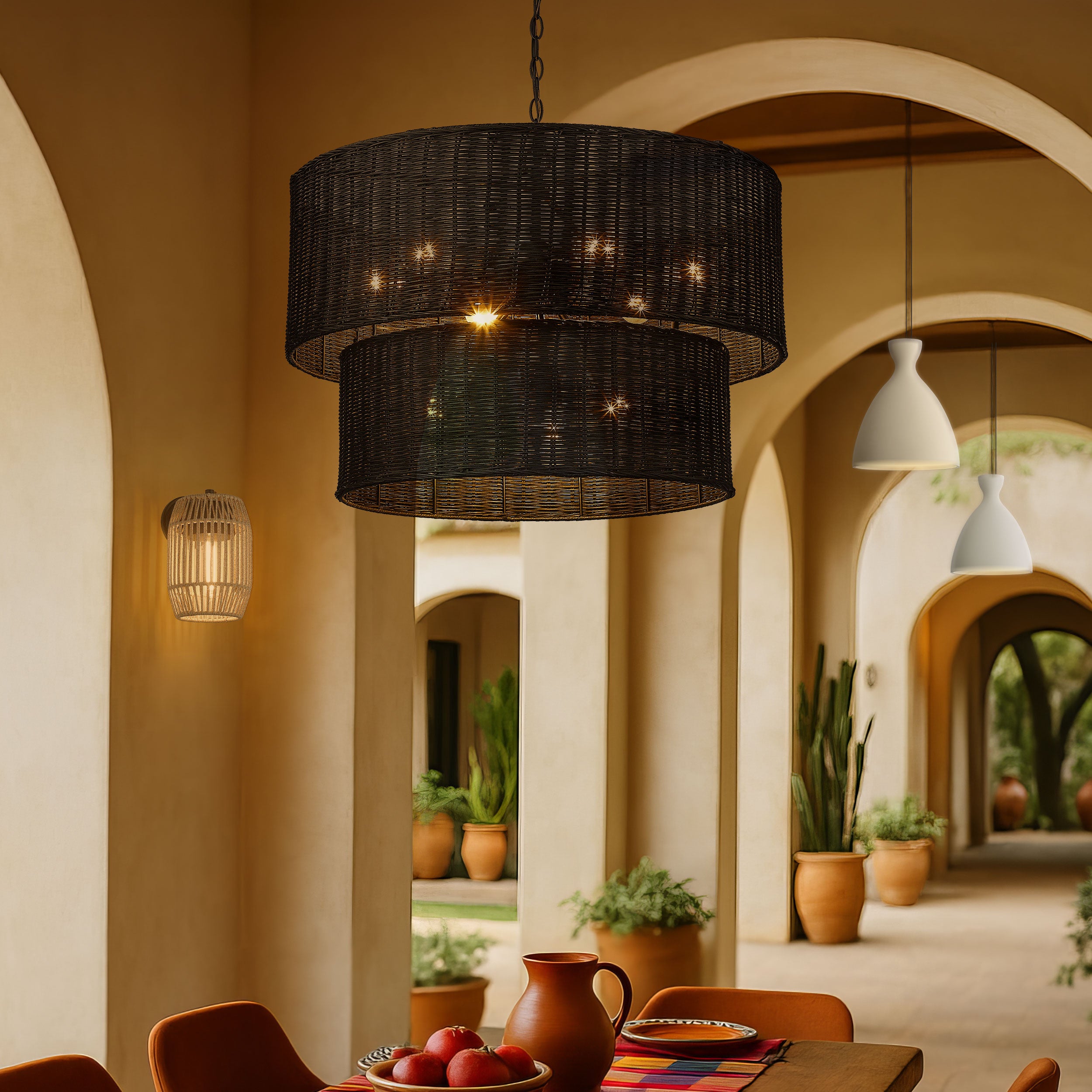 Outdoor seating area with Erma 9-Light Chandelier in Black Wicker, Seabrooke 12" Tall Outdoor Wall Sconce in Natural Black with Summer Sands, and Aethera 14" Concrete pendants in White Sandstone - Golden Lighting