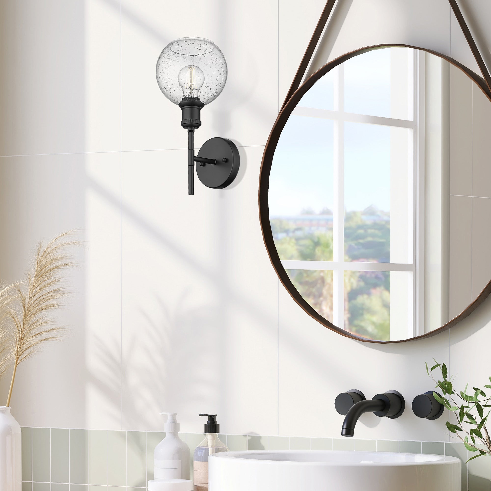 Axel 1-light Wall Sconce in Matte Black and Globe Seeded Glass, shown in a room setting - Golden Lighting