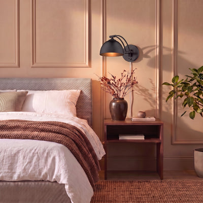 Rey 1-light Swing Arm Wall Lamp in Matte Black, AI-visualized bedroom scene - Golden Lighting