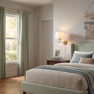 Eleanor 1-light Swing Arm Wall Lamp in Brushed Champagne Brass, AI-visualized bedroom scene - Golden Lighting