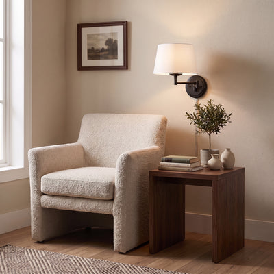 Eleanor 1-light Swing Arm Wall Lamp in Matte Black, AI-visualized reading nook scene - Golden Lighting