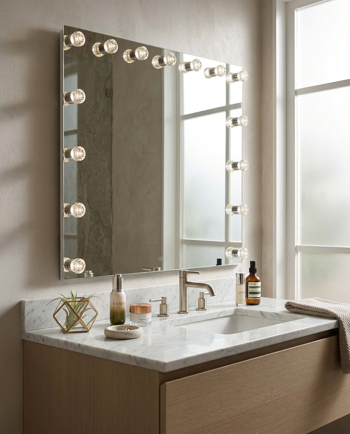 Starlight 48" LED Mirror shown installed as a Bathroom vanity with a large mirror featuring lights and various toiletries.